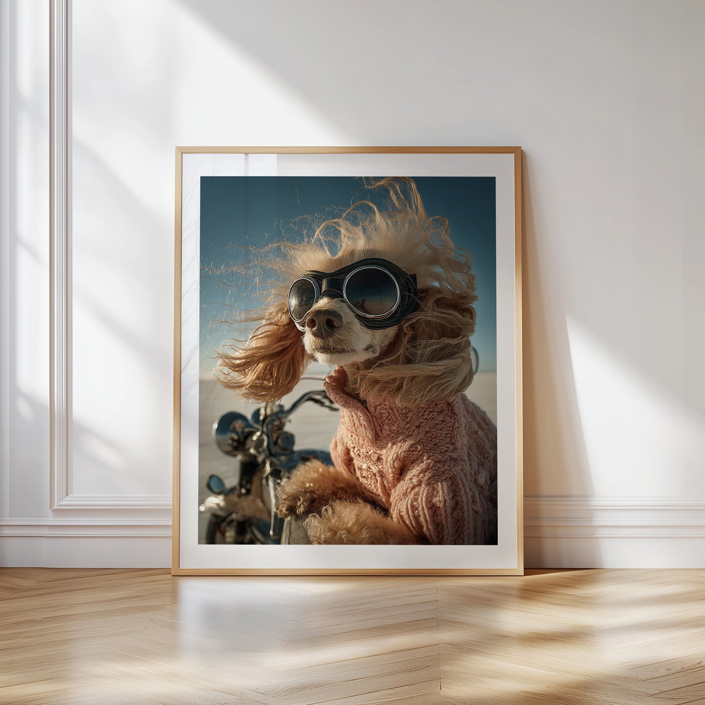 Funny apricot poodle with retro aviator goggles and pink sweater riding a motorcycle. Printed as premium wall art on FSC-certified semi-glossy paper (200 gsm), perfect for bathroom, guest toilet, or dog lovers' spaces. Available in DIN and standard poster sizes. Quirky and eye-catching decoration. Be proud. Be kind. Be wild – by Dezinbazar.