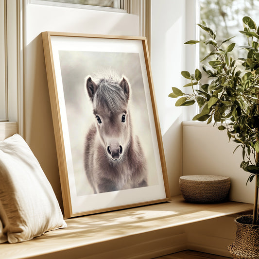 Adorable baby pony poster in soft neutral tones – perfect for nurseries, kids rooms or farm-themed interiors. Printed on 200 gsm semi-glossy FSC-certified paper. Available in DIN A4–A0 and standard sizes like 30×40 cm and 50×70 cm. Made to order and eco-friendly. Ideal gift for pony lovers and baby room decoration. Be proud. Be kind. Be wild – by Dezinbazar.