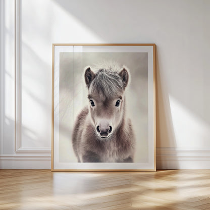 Adorable baby pony poster in soft neutral tones – perfect for nurseries, kids rooms or farm-themed interiors. Printed on 200 gsm semi-glossy FSC-certified paper. Available in DIN A4–A0 and standard sizes like 30×40 cm and 50×70 cm. Made to order and eco-friendly. Ideal gift for pony lovers and baby room decoration. Be proud. Be kind. Be wild – by Dezinbazar.