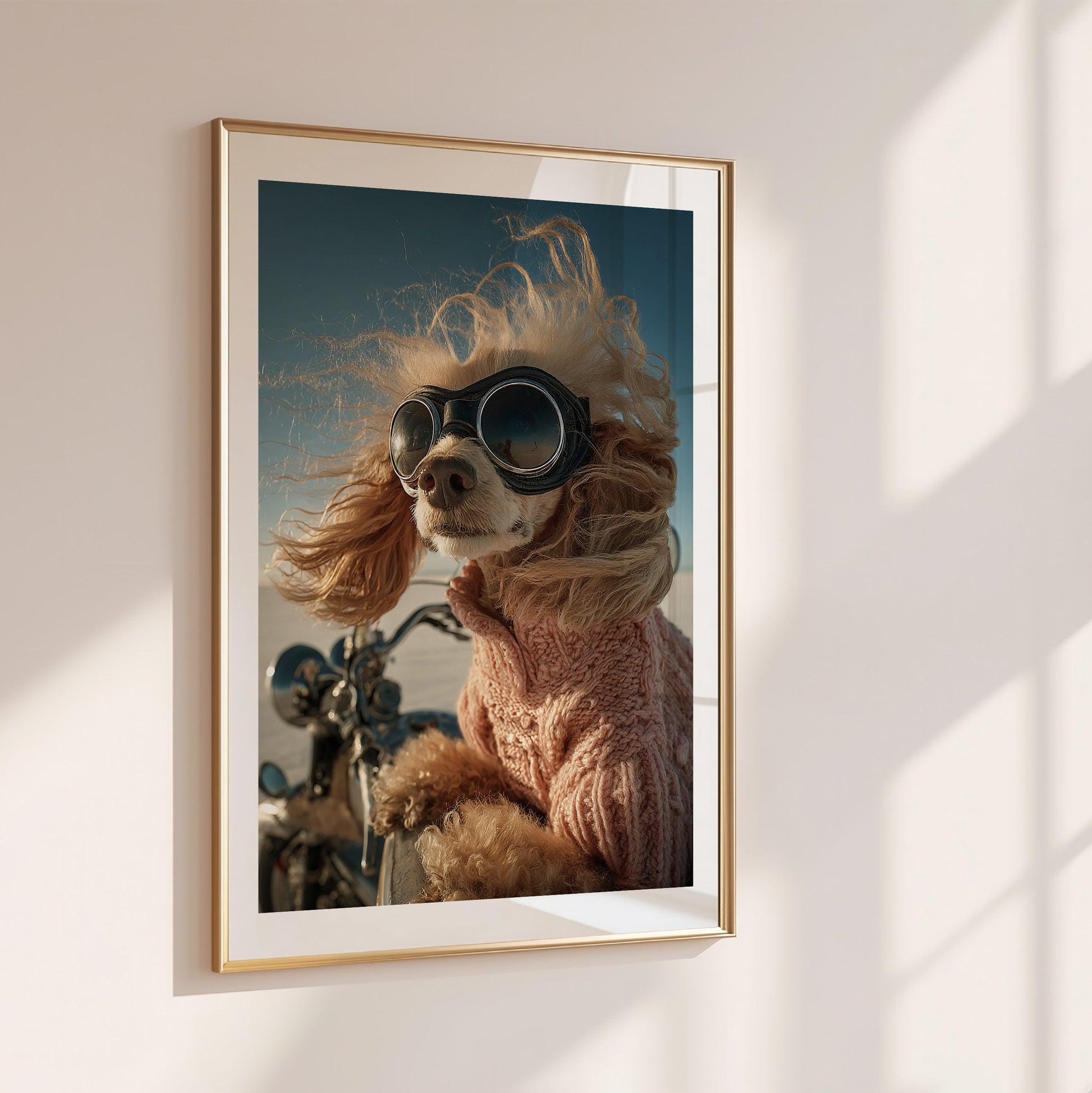 Funny apricot poodle with retro aviator goggles and pink sweater riding a motorcycle. Printed as premium wall art on FSC-certified semi-glossy paper (200 gsm), perfect for bathroom, guest toilet, or dog lovers' spaces. Available in DIN and standard poster sizes. Quirky and eye-catching decoration. Be proud. Be kind. Be wild – by Dezinbazar.